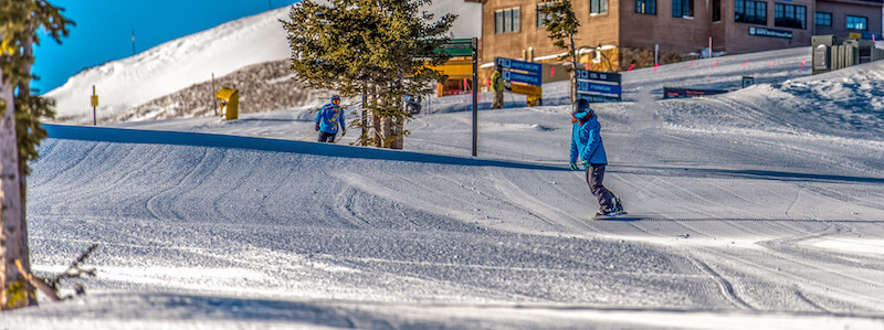 snowboarder coming from super bee chairlift at copper mountain